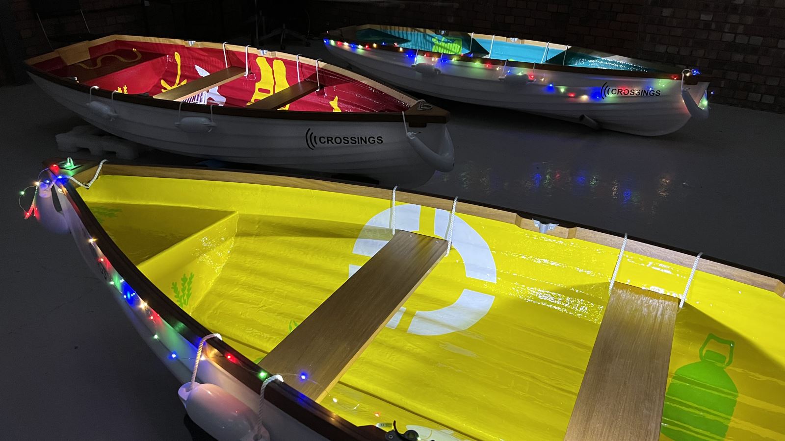 Brightly coloured illuminated rowing boats